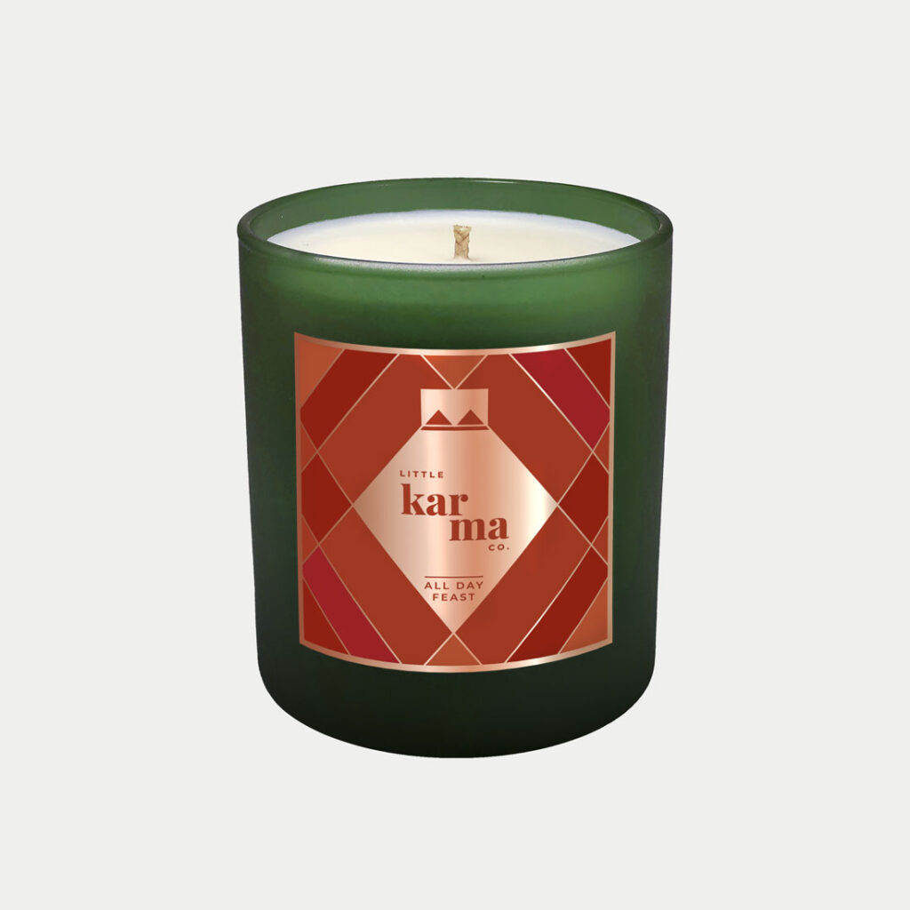 All Day Feast sweet cinnamon refillable Christmas candle in a festive green glass finished with a luxurious rose gold foil label